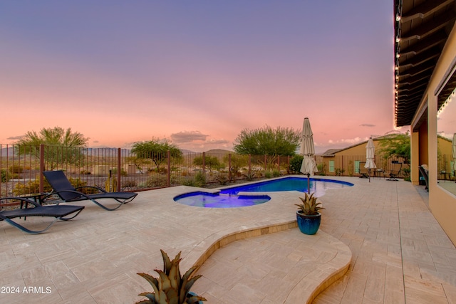 pool at dusk with a patio