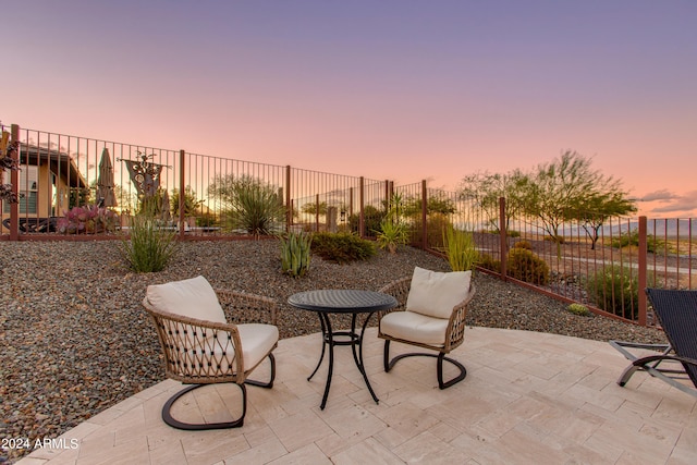 view of patio terrace at dusk