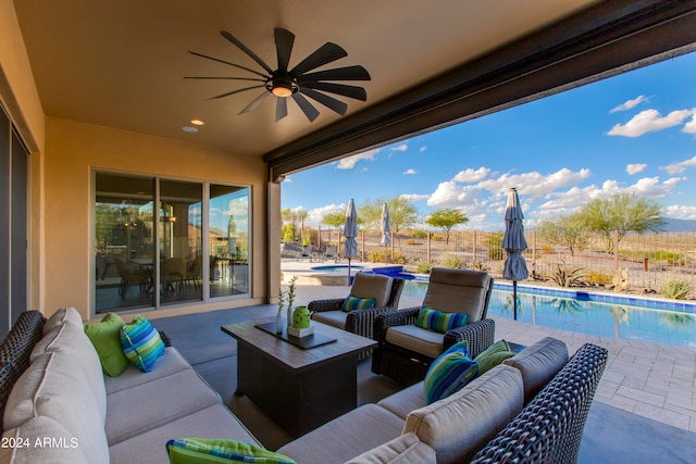 view of patio featuring an outdoor living space, a fenced in pool, and ceiling fan