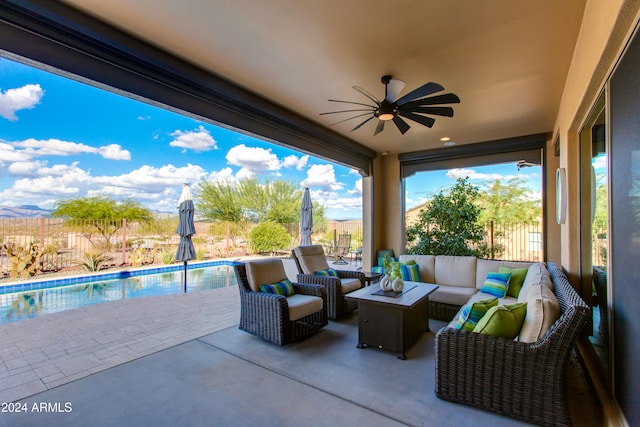 view of patio / terrace featuring a fenced in pool, outdoor lounge area, and ceiling fan