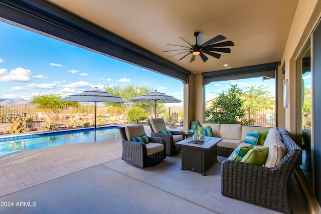 view of patio / terrace featuring an outdoor living space, a fenced in pool, and ceiling fan