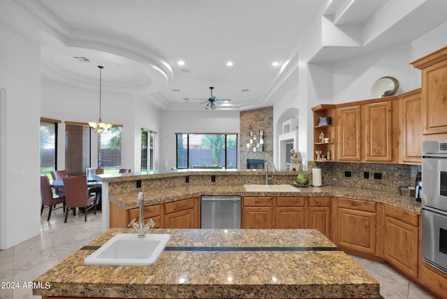 kitchen with a kitchen island with sink, sink, and stainless steel appliances