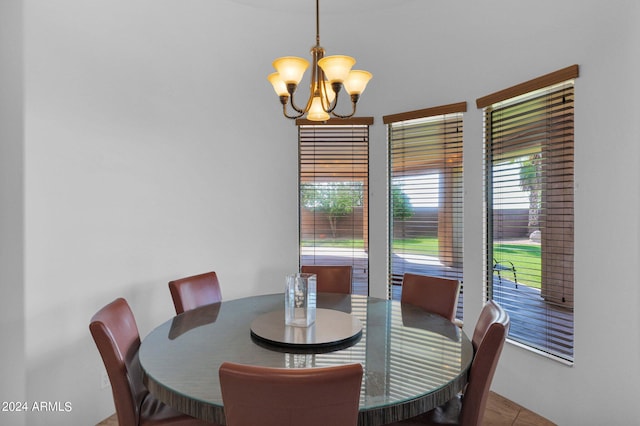 dining room featuring a notable chandelier and light tile patterned flooring