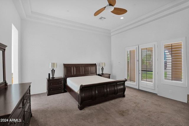 bedroom featuring ceiling fan, access to exterior, a raised ceiling, and carpet