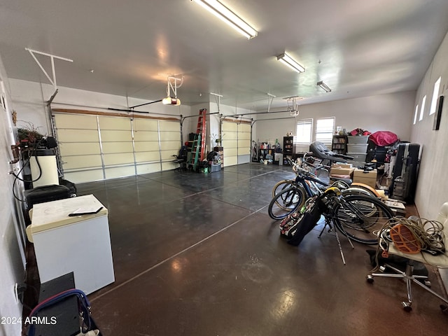 garage with a garage door opener and refrigerator