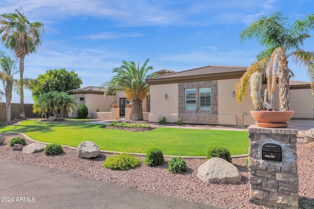 mediterranean / spanish home featuring a front yard