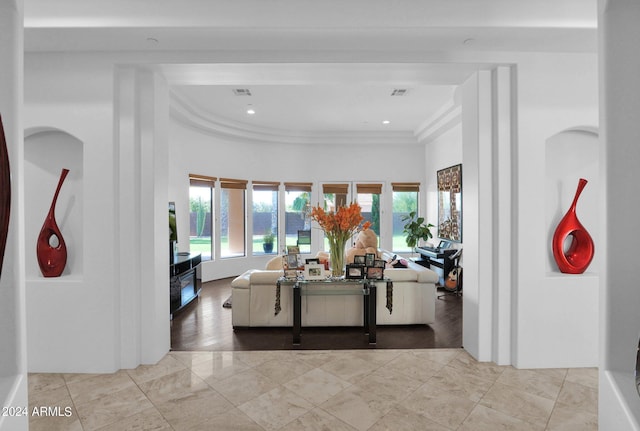 living room with ornamental molding, a healthy amount of sunlight, and light tile patterned flooring