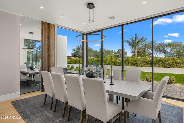 sunroom / solarium with a notable chandelier