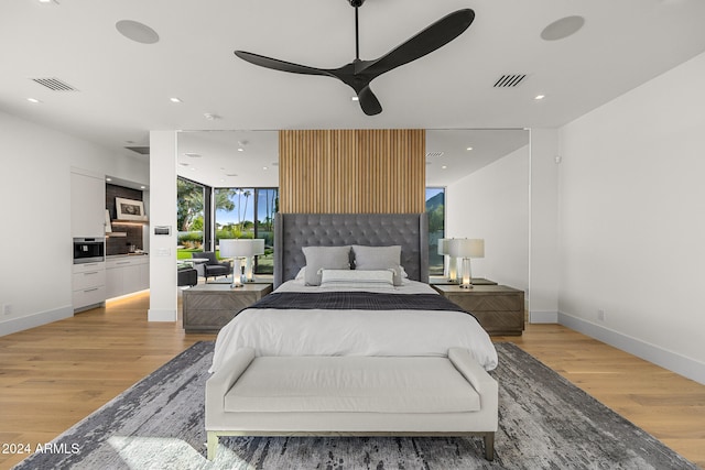 bedroom featuring ceiling fan and light hardwood / wood-style flooring