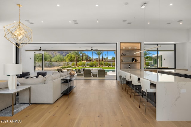 living room featuring a notable chandelier and light hardwood / wood-style flooring