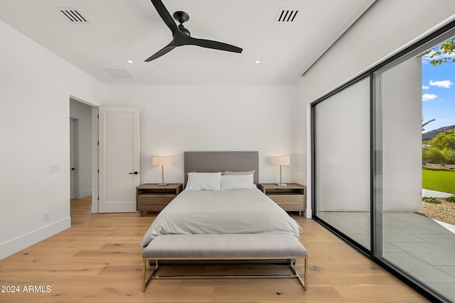 bedroom with access to outside, light hardwood / wood-style floors, and ceiling fan