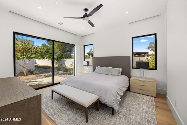 bedroom featuring light wood-type flooring, access to outside, and ceiling fan