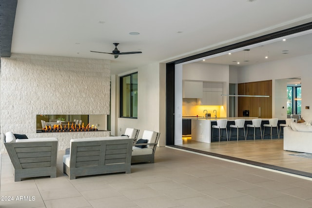 view of patio / terrace with an outdoor bar and ceiling fan