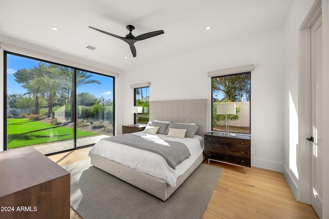 bedroom with ceiling fan, light hardwood / wood-style floors, and access to exterior