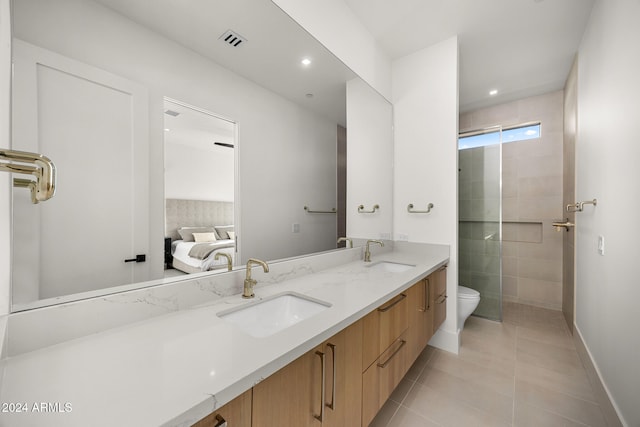 bathroom featuring tile patterned flooring, an enclosed shower, vanity, and toilet