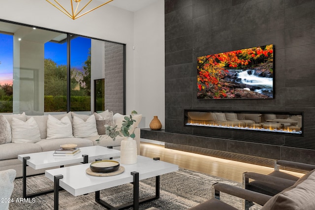 living room with a large fireplace and hardwood / wood-style flooring