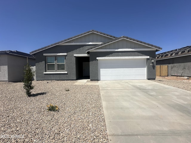 46922 W Coe St, Maricopa, AZ 85139 - ranch-style home featuring an attached garage, a tile roof, concrete driveway, and stucco siding