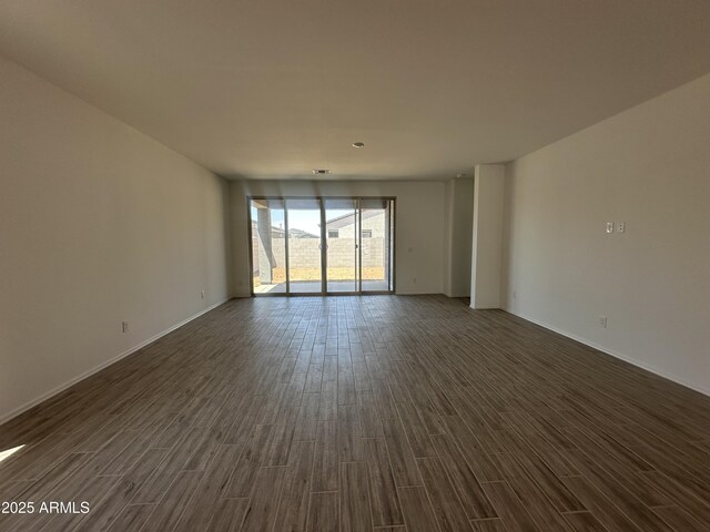 46922 W Coe St, Maricopa, AZ 85139 - empty room with dark wood finished floors and baseboards