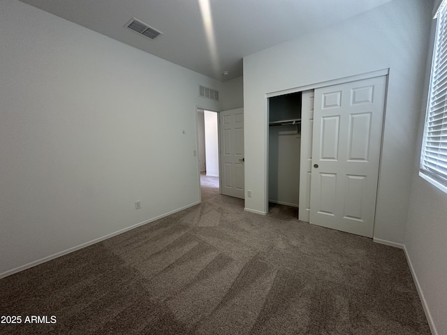 46922 W Coe St, Maricopa, AZ 85139 - unfurnished bedroom featuring carpet flooring, a closet, and baseboards