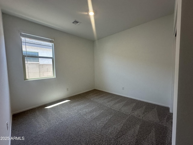 46922 W Coe St, Maricopa, AZ 85139 - spare room with dark colored carpet and baseboards