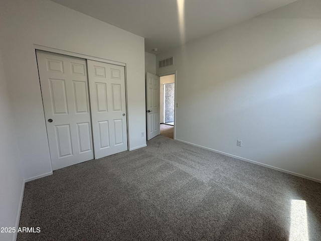 46922 W Coe St, Maricopa, AZ 85139 - unfurnished bedroom featuring dark carpet, a closet, and baseboards