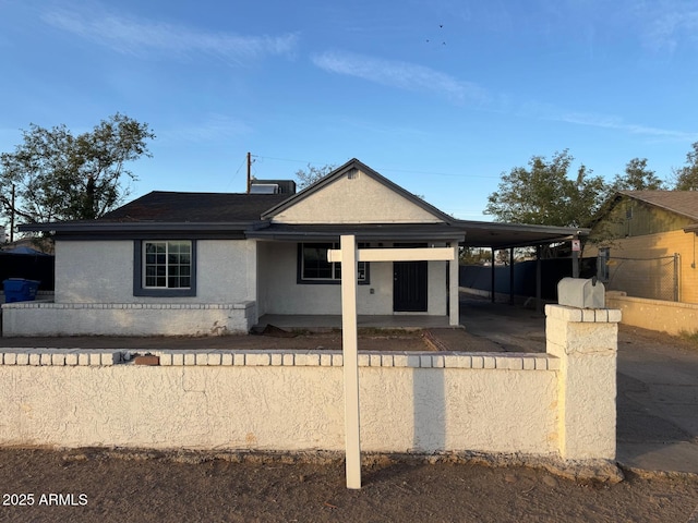 view of front of property featuring covered porch and a carport