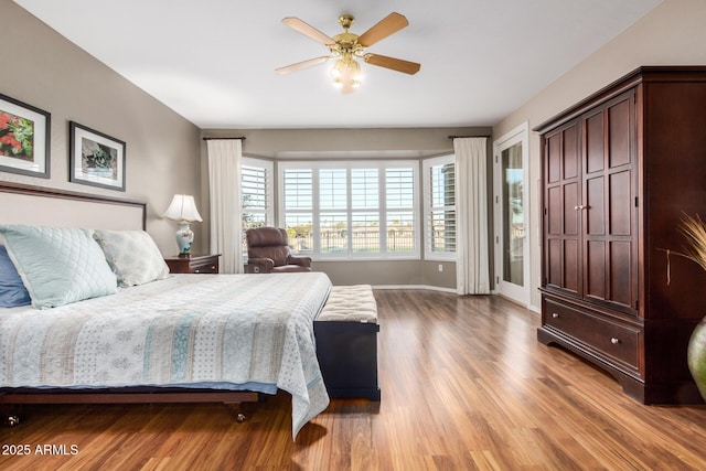 bedroom featuring ceiling fan, light wood finished floors, and baseboards