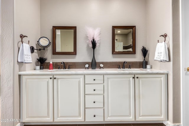 full bath with a sink and double vanity