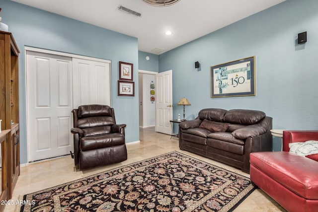 living area featuring recessed lighting, visible vents, and baseboards