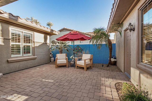 view of patio / terrace featuring fence