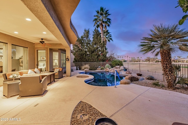 pool at dusk featuring a fenced in pool, a patio, a ceiling fan, a fenced backyard, and an outdoor living space