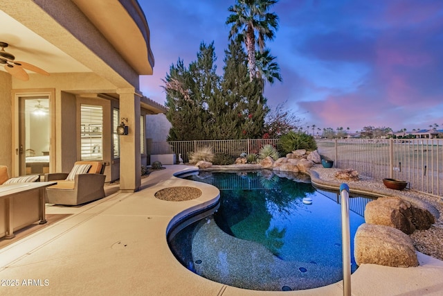 view of swimming pool with a patio area, a fenced backyard, a ceiling fan, and a fenced in pool