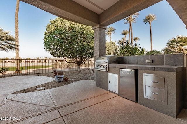 view of patio with area for grilling and fence