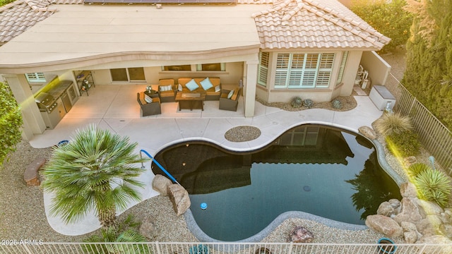 exterior space with a fenced backyard, an outdoor hangout area, and a patio