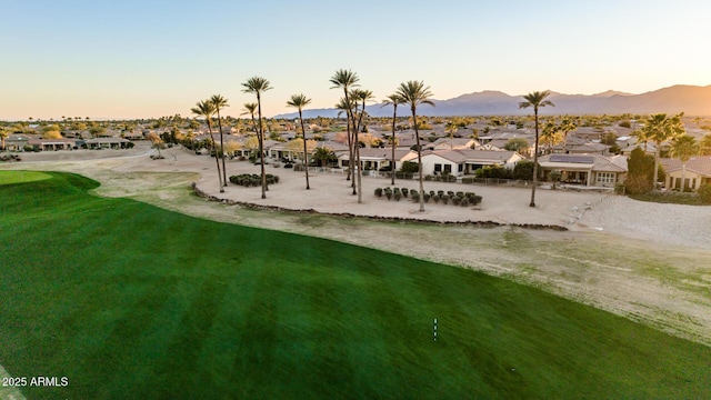 view of community with a residential view, a mountain view, and a lawn