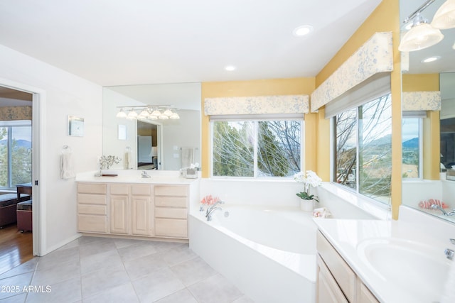 ensuite bathroom with connected bathroom, a garden tub, tile patterned flooring, vanity, and recessed lighting