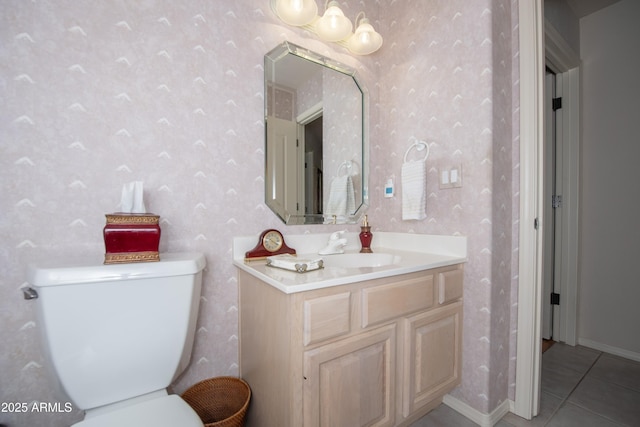 bathroom with tile patterned floors, vanity, toilet, and wallpapered walls