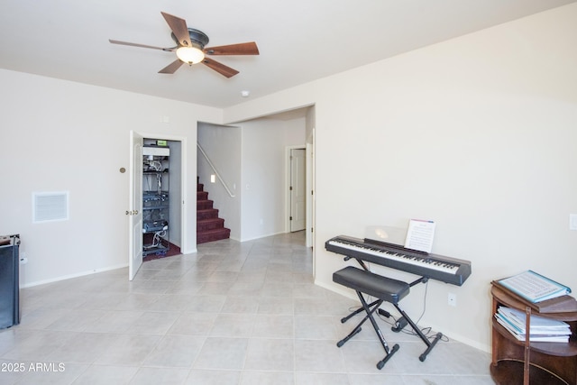 miscellaneous room with visible vents, ceiling fan, stairway, and baseboards