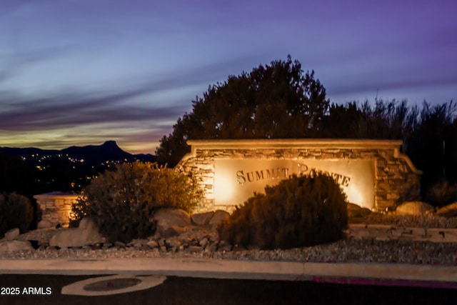 property exterior at dusk with stone siding