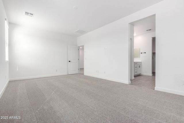 unfurnished bedroom with baseboards, visible vents, and light colored carpet