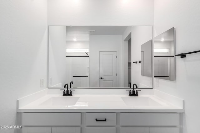 bathroom featuring double vanity and a sink