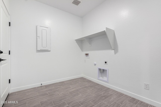 laundry area featuring gas dryer hookup, hookup for an electric dryer, laundry area, wood finish floors, and visible vents