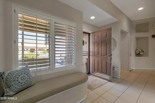 foyer featuring light tile patterned floors, recessed lighting, and baseboards