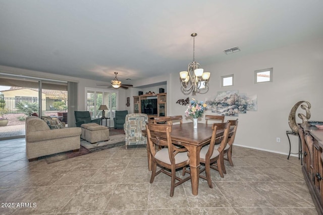 dining room featuring ceiling fan with notable chandelier