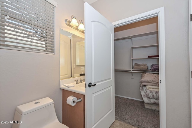 bathroom with tile patterned floors, vanity, and toilet