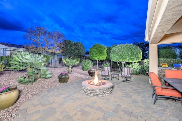 patio terrace at dusk with a fire pit