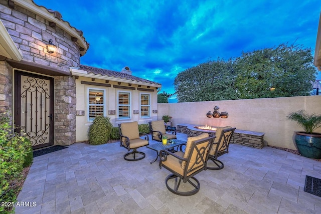 patio terrace at dusk with a fire pit