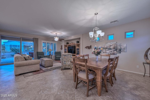 dining space with ceiling fan with notable chandelier