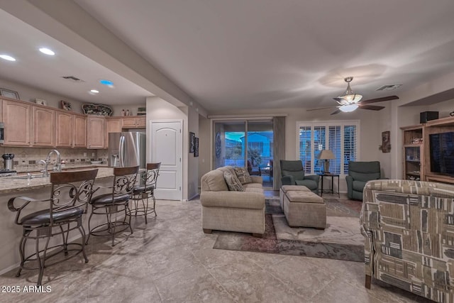 living room with sink and ceiling fan