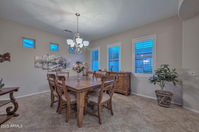 dining area featuring a notable chandelier